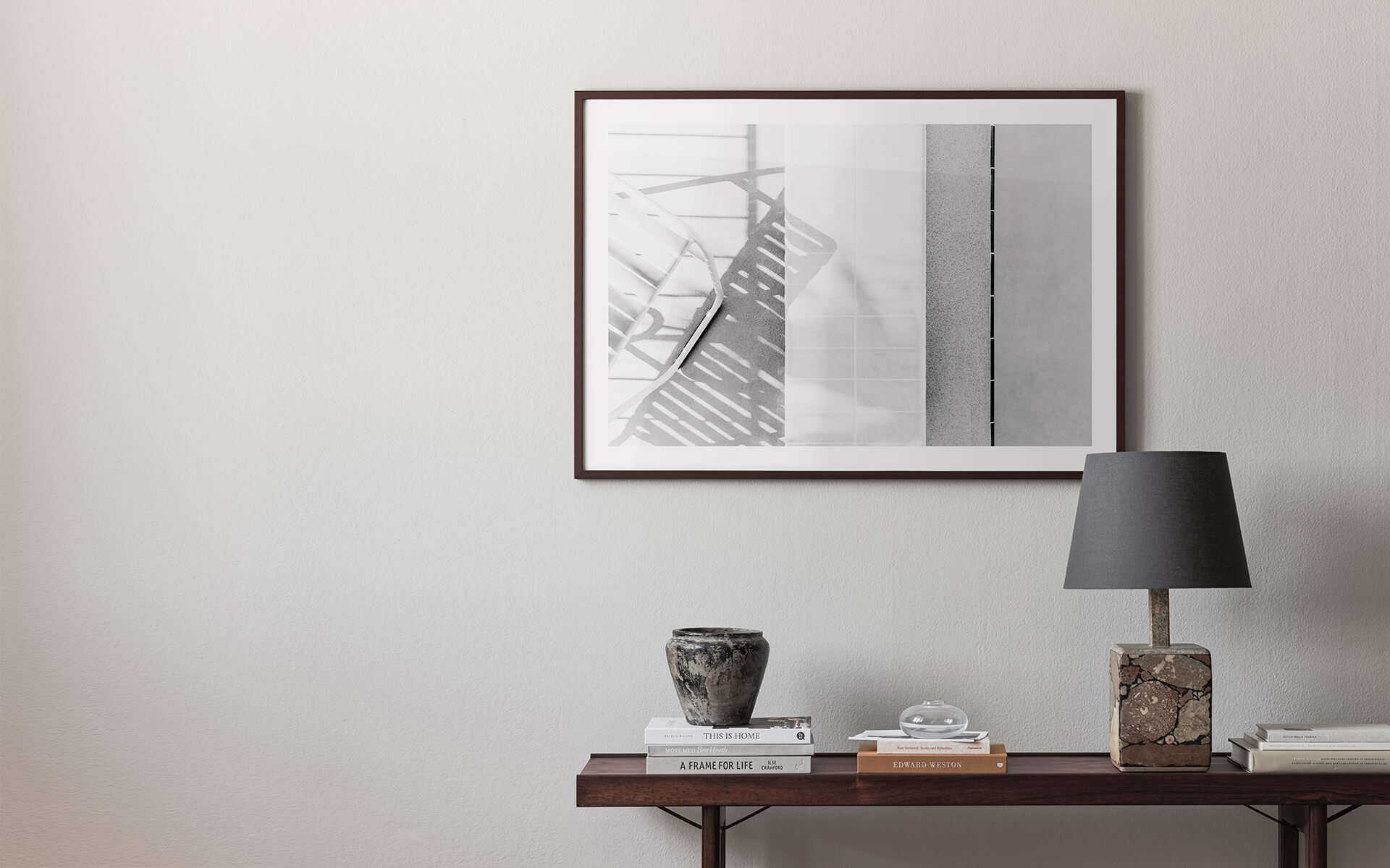 Minimalistic scandinavian interior with black and white photo art in wooden frame