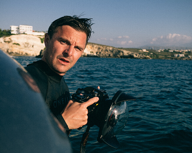 Niklas nyman with an underwater camera on a boat