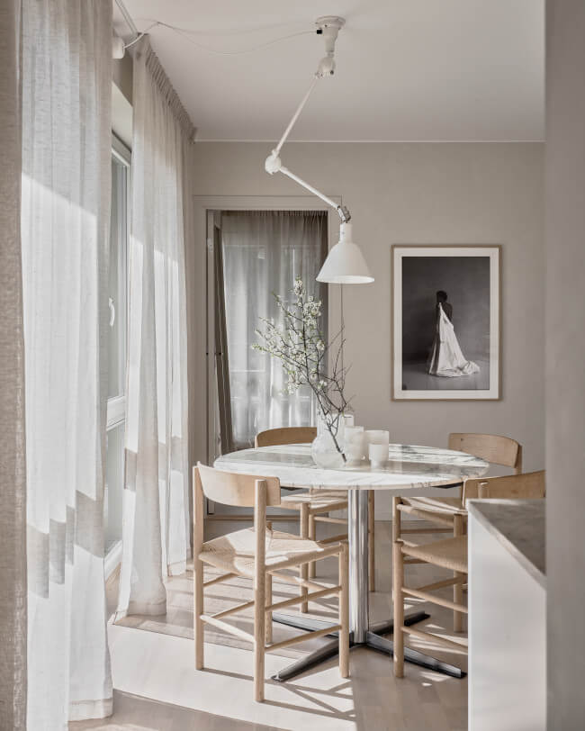 A beige kitchen with a big artwork by felicia masalla
